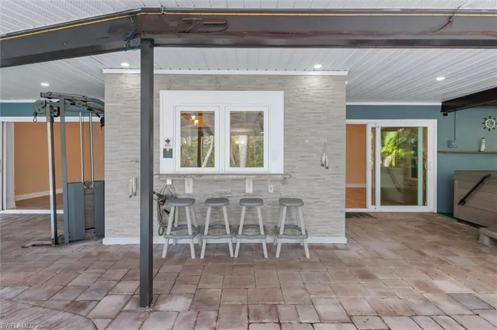 View of patio with exterior bar