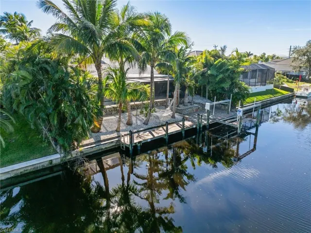 Dock area with glass enclosure and a water view