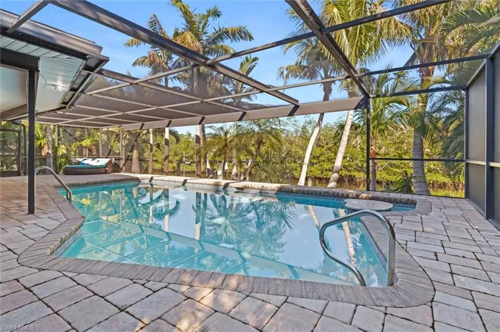 View of swimming pool featuring a lanai and a patio