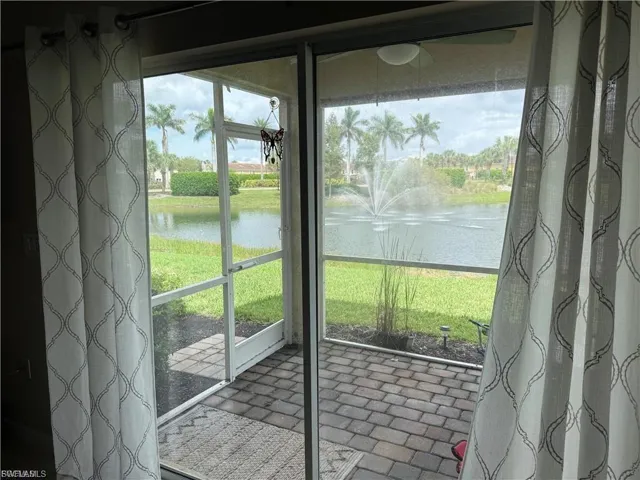 Unfurnished sunroom featuring a water view