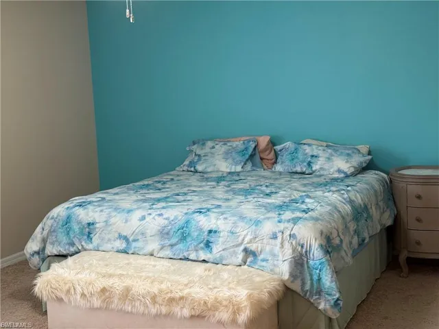 Bedroom with carpet floors and baseboards