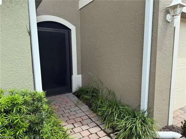 Property entrance featuring stucco siding