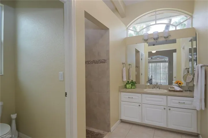 Bathroom with tile floors, vanity, and toilet