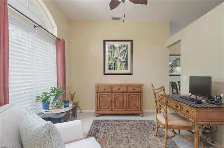 Tiled office space featuring ceiling fan