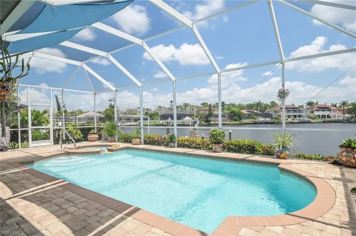 View of swimming pool with a patio and a lanai