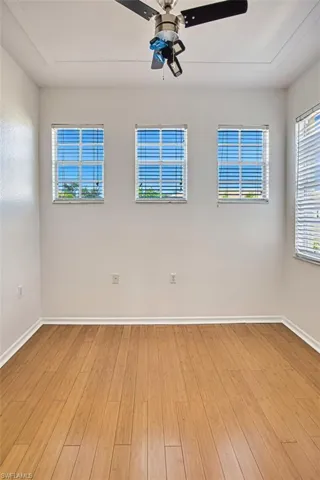 Unfurnished room featuring light wood-style floors and ceiling fan