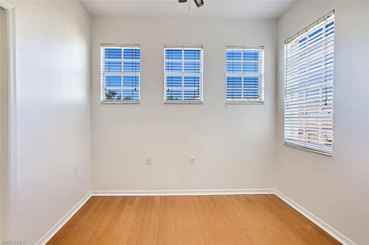 Empty room featuring light wood-type flooring and plenty of natural light