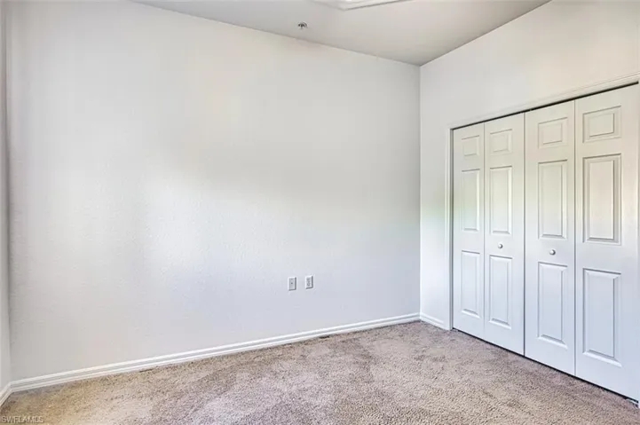 Unfurnished bedroom with carpet floors and a closet