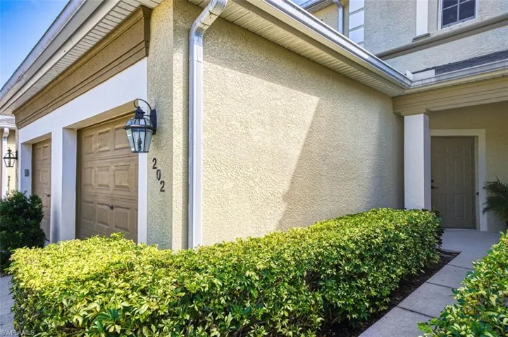 View of side of home featuring stucco siding and a garage