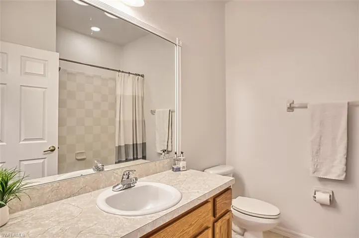 Full bathroom with vanity and a shower with shower curtain