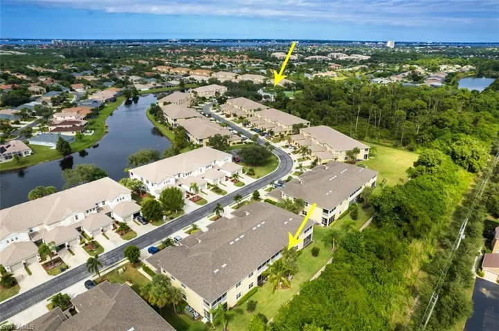 Aerial view of property and surrounding area with nearby suburban area and a large body of water