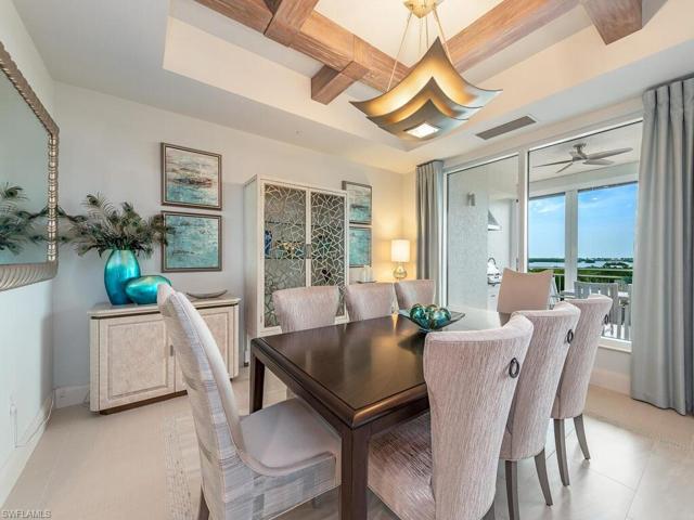 Enjoy the view as you watch sunset and sharing a meal with your friends in this lovely dining room with custom draperies and wood detailing in the celing.