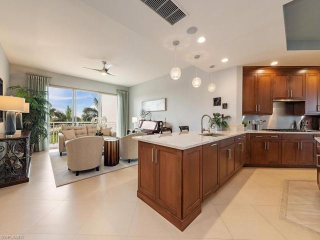 Family room with powered shades, breakfast bar and updated kitchen with newer quartz countertops.