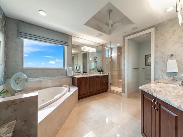Large master bathroom complete with jacuzzi tub, his/her vanities, walk in shower and built-in vanity for her.  The 03 units are the only units with a window in the bathroom.