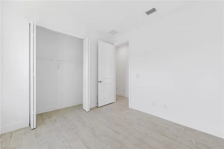 Unfurnished bedroom featuring a closet and light wood-type flooring
