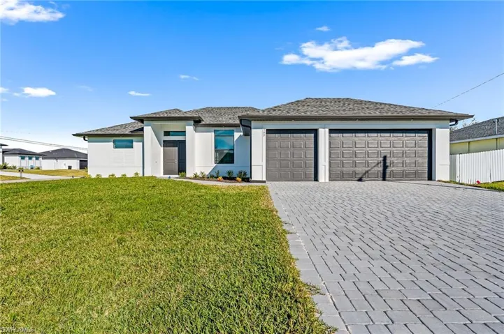 Prairie-style home with a front lawn and a garage