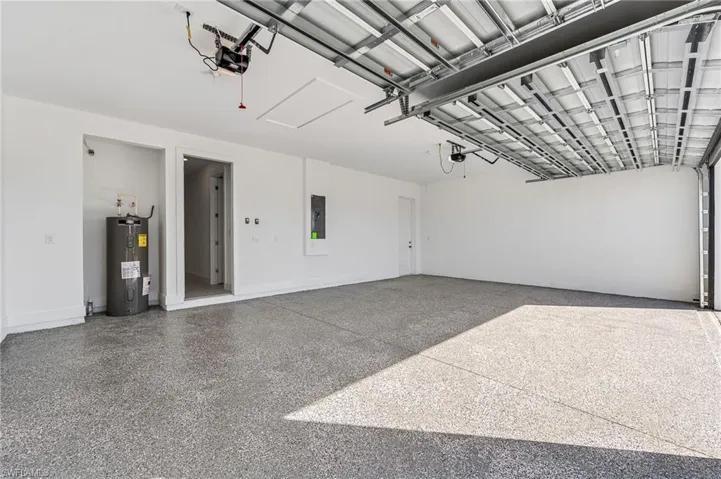 Garage with water heater and a garage door opener