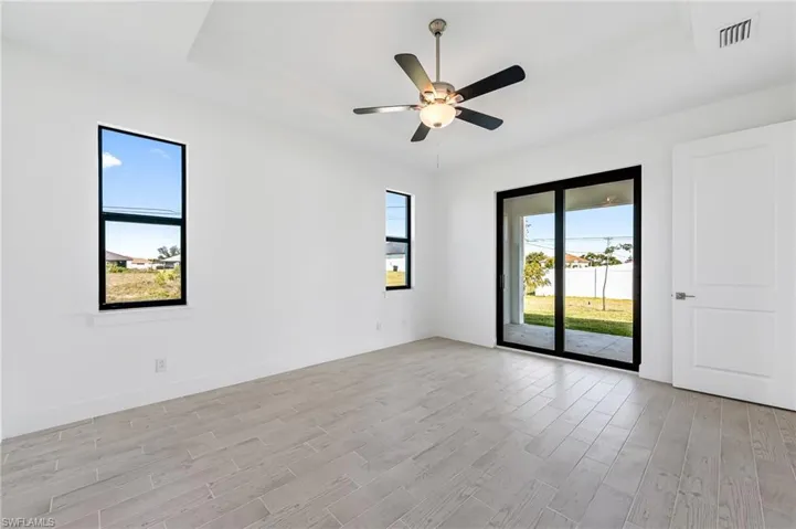 Unfurnished room with ceiling fan and light wood-type flooring
