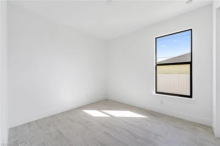 Unfurnished room with light hardwood / wood-style flooring