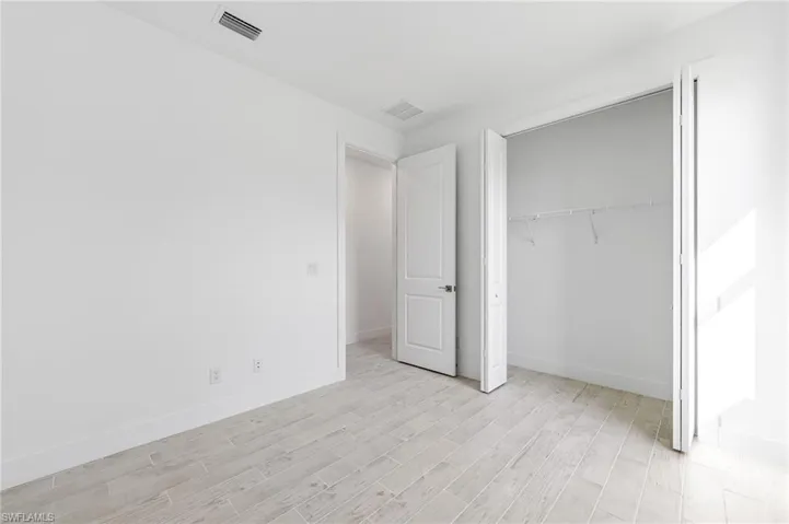 Unfurnished bedroom featuring a closet and light wood-type flooring
