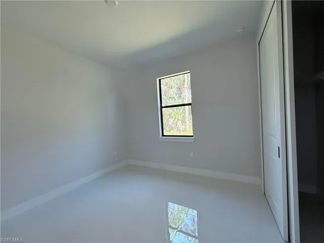 Unfurnished bedroom with a closet and baseboards