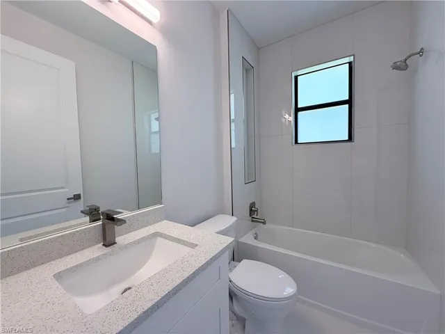 Full bath featuring shower / tub combination and vanity