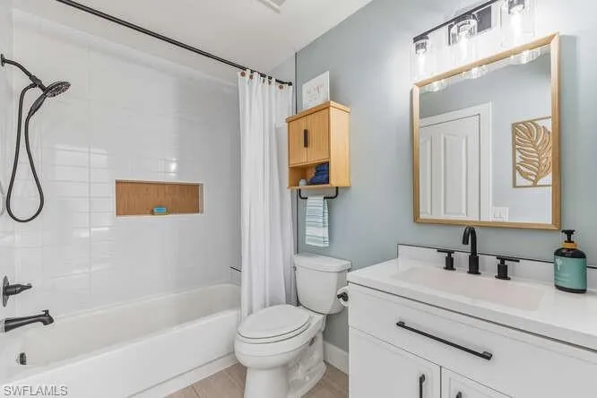 Updated Guest Bathroom with new vanity and shower / bath combo, and tile flooring.