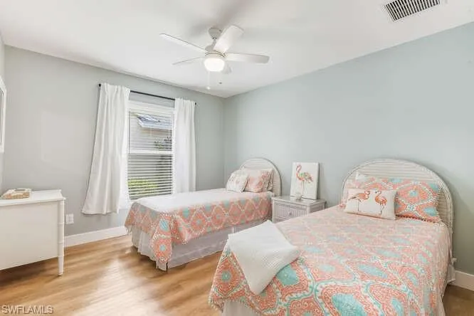 Guest Bedroom two featuring all new LVT flooring, ensuite bath, and a ceiling fan.