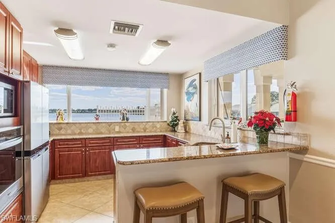 Community Kitchen in the clubhouse featuring SS appliances, granite counters, and water views.