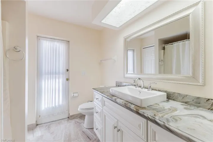 Bathroom featuring curtained shower and vanity