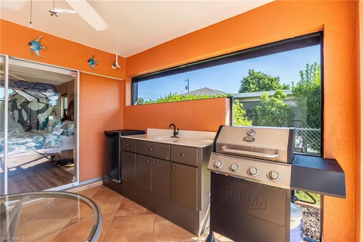 View of patio / terrace with grilling area and a sink