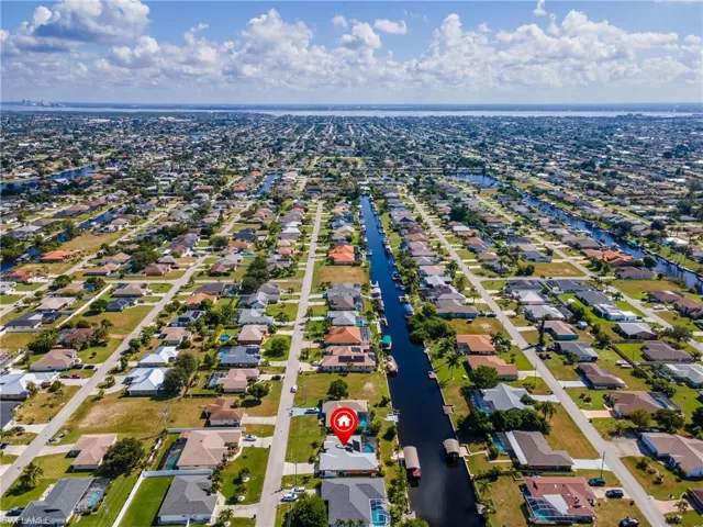 Aerial overview of property's location with a large body of water and nearby suburban area