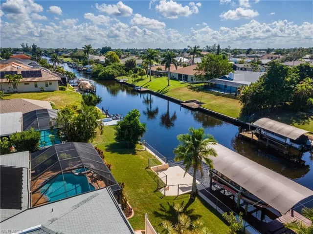 Aerial view of residential area featuring a nearby body of water