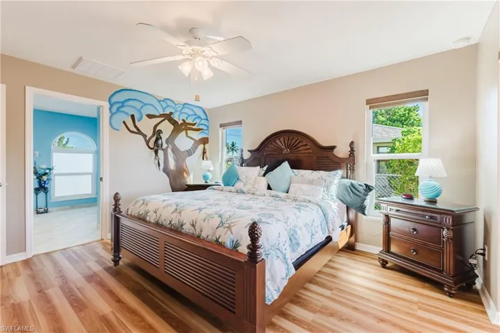 Bedroom with light wood finished floors and a ceiling fan