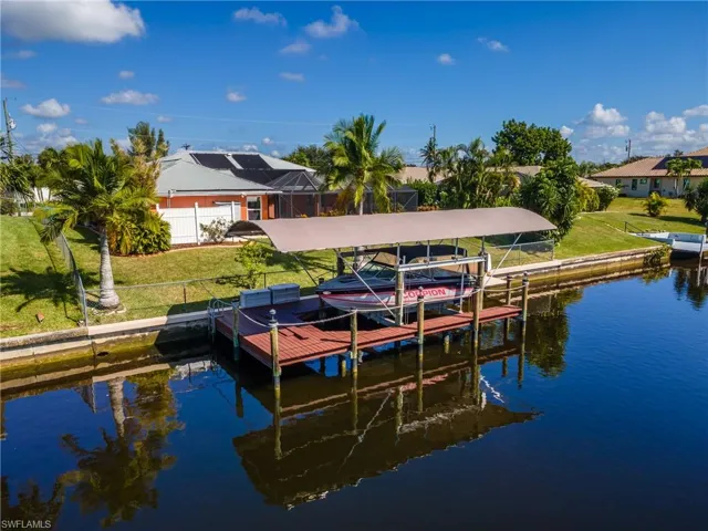 Dock area featuring boat lift and a water view