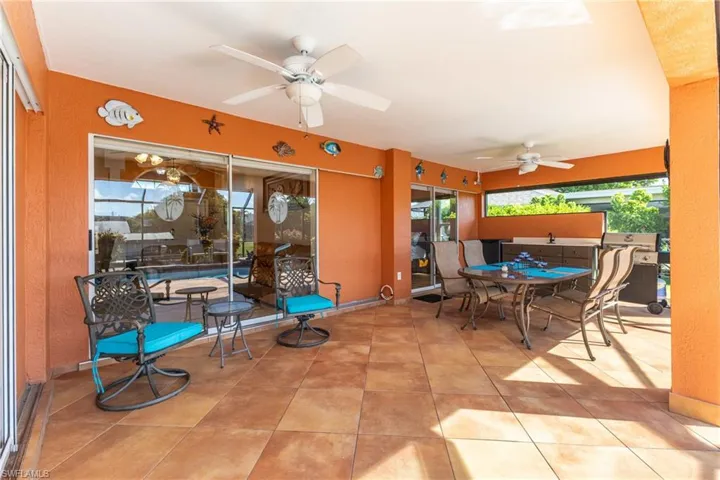 View of patio / terrace featuring outdoor dining area, grilling area, and a ceiling fan