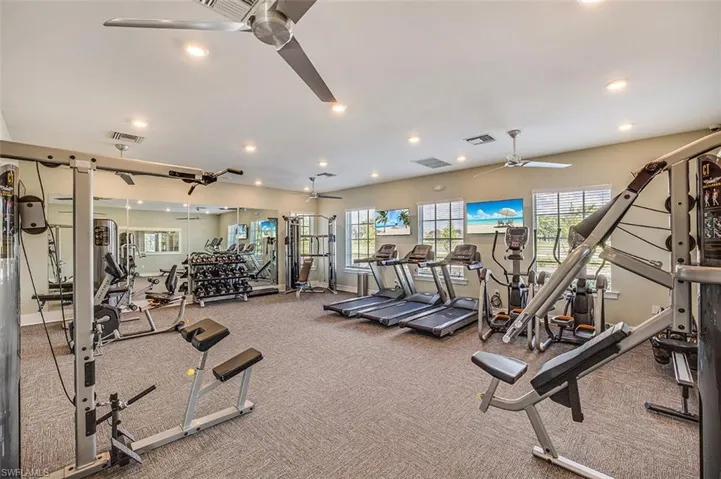 Exercise room featuring recessed lighting, a ceiling fan, and carpet flooring
