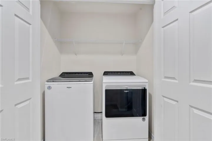 Laundry area with washing machine and clothes dryer
