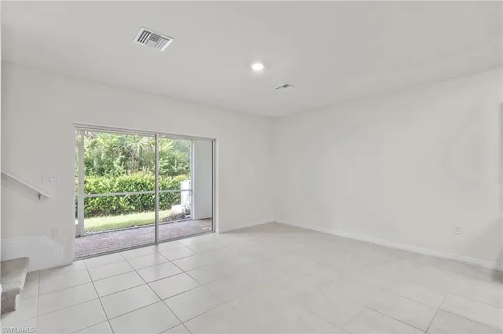 Unfurnished room with stairway, light tile patterned floors, and recessed lighting