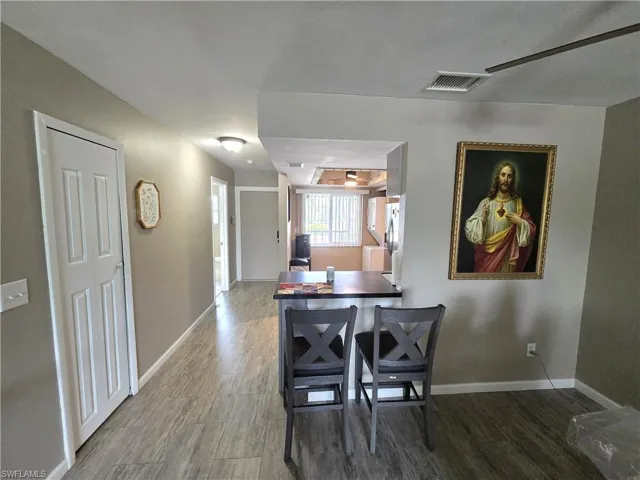Wood-finish flooring throughout, with a built-in breakfast bar featuring a dark countertop