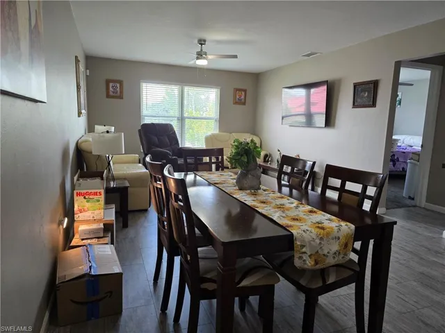 Wood-finish flooring throughout, with a recessed ceiling fan light fixture, and horizontal blinds on windows