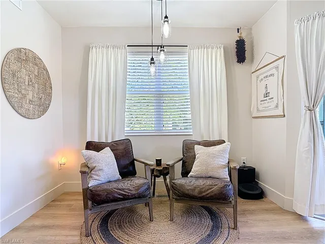 Living area with light wood-type flooring and baseboards
