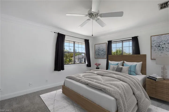 Bedroom featuring multiple windows, carpet, ornamental molding, and visible vents