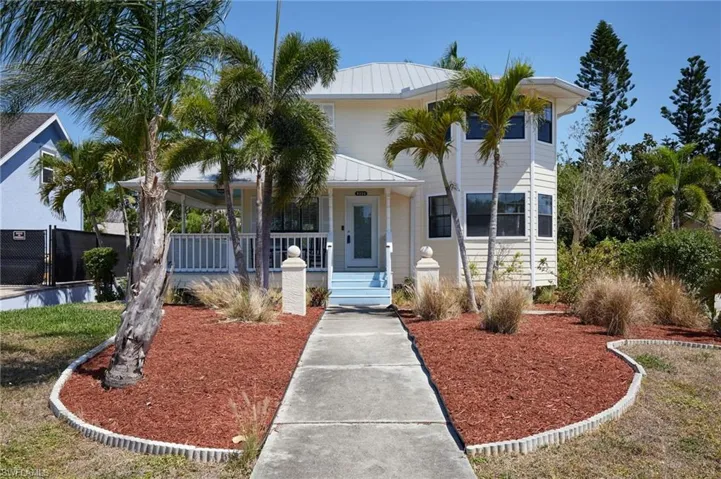 View of front of home featuring a porch and metal roof