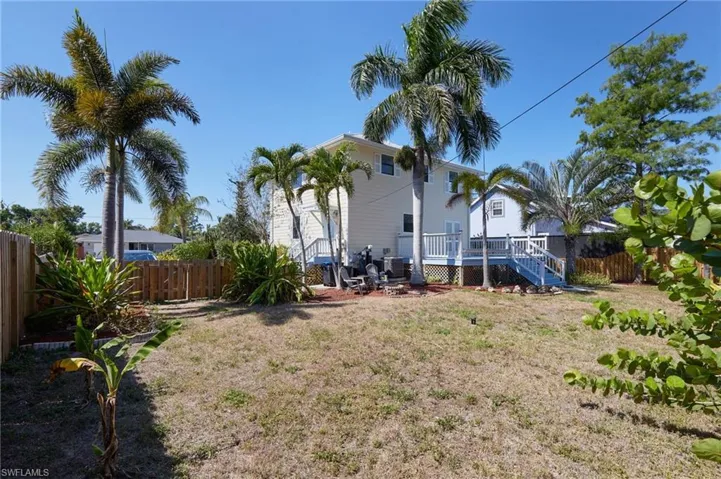 View of yard with a fenced backyard, a wooden deck, and stairway
