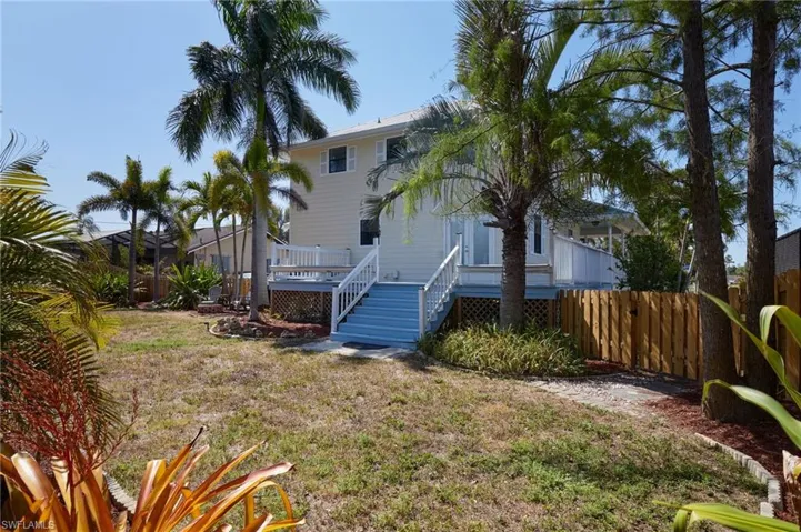 View of yard with a wooden deck and fence