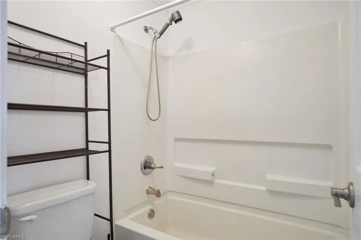Bathroom with washtub / shower combination and toilet