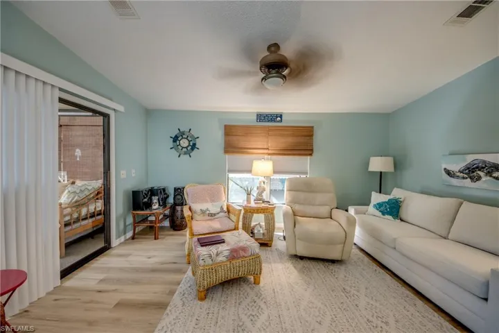 Living area featuring wood finished floors and a ceiling fan