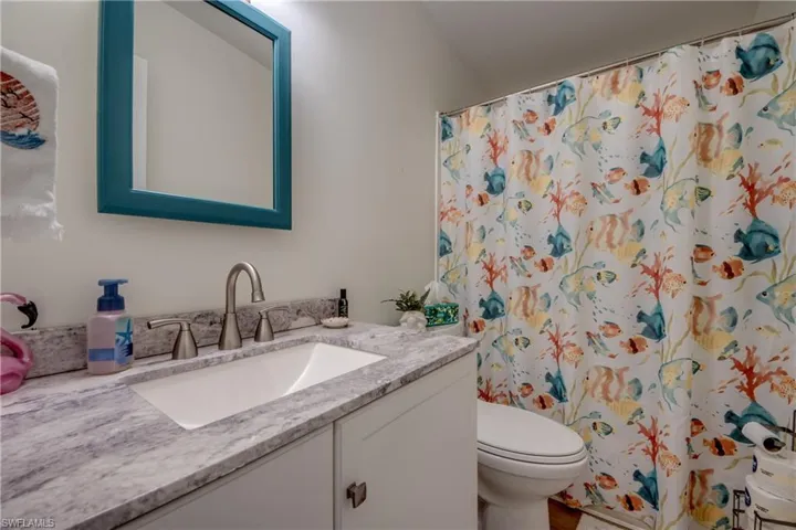 Full bath featuring vanity and a shower with curtain
