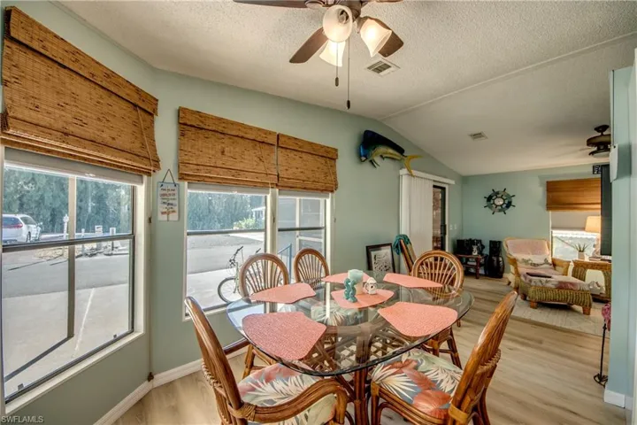 Dining space with a ceiling fan and light wood finished floors